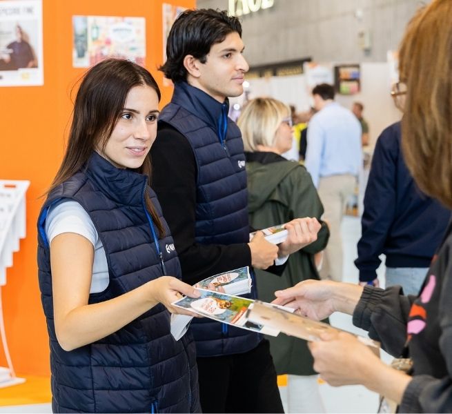 Girl handing document at the entry of the show Gourmet Selection