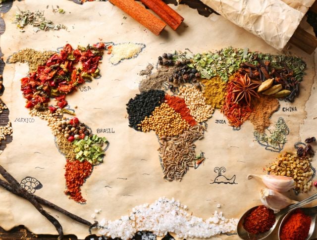 World map illustrated with colorful spices representing the flavors of different countries.