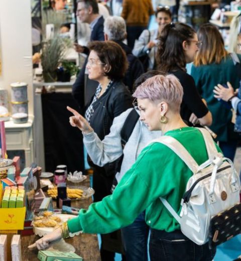 View of a busy stand at Gourmet Selection, with visitors exploring gourmet grocery products