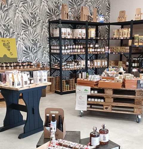 Friendly and rustic interior of Bien & Bon grocery store featuring wooden displays offering a diverse range of local products.