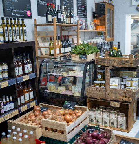 Local grocery Maison Paulette featuring high chairs, a welcoming counter, and artisanal products.