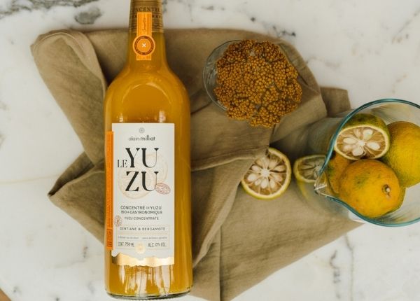 Bottle of gastronomic yuzu concentrate on a marble table